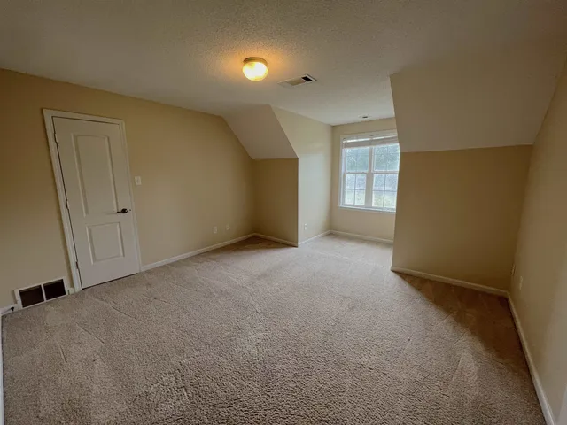 a bathroom with a double vanity sink a mirror and a bathtub