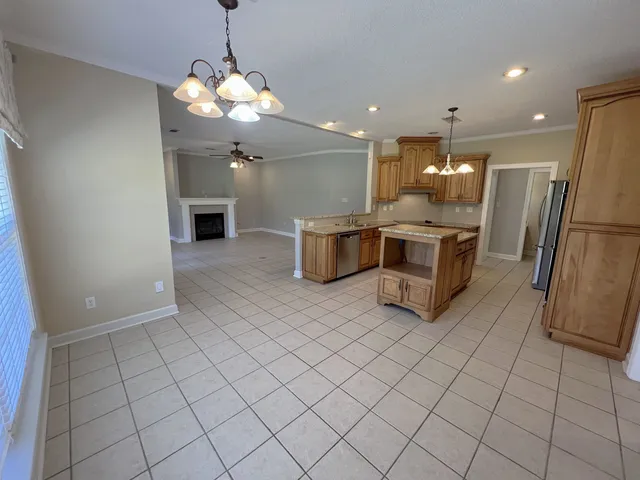 an empty room with windows and fireplace