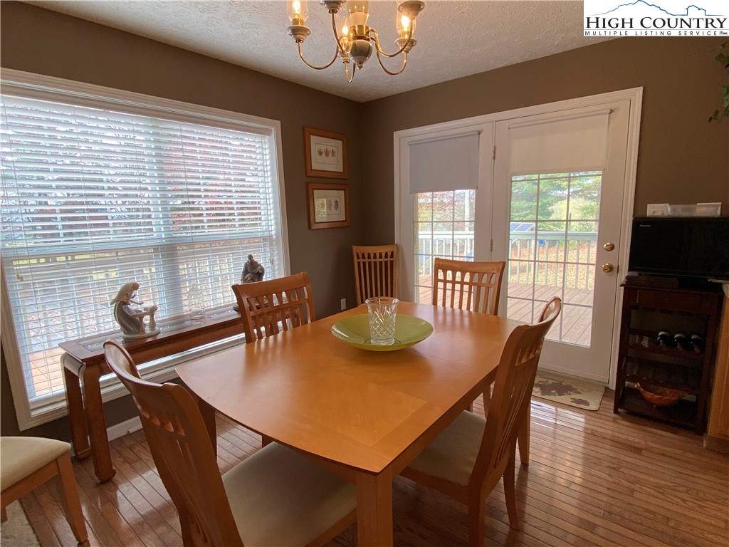 1241 Glade Creek School Road Ennice, NC 28623 - Photo 15 of 49 a view of a dining room with furniture window and wooden floor