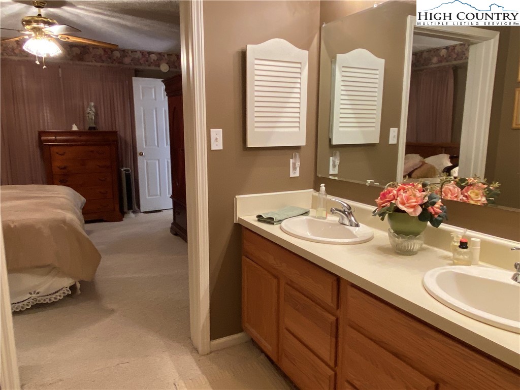1241 Glade Creek School Road Ennice, NC 28623 - Photo 21 of 49 a bathroom with a sink and a mirror