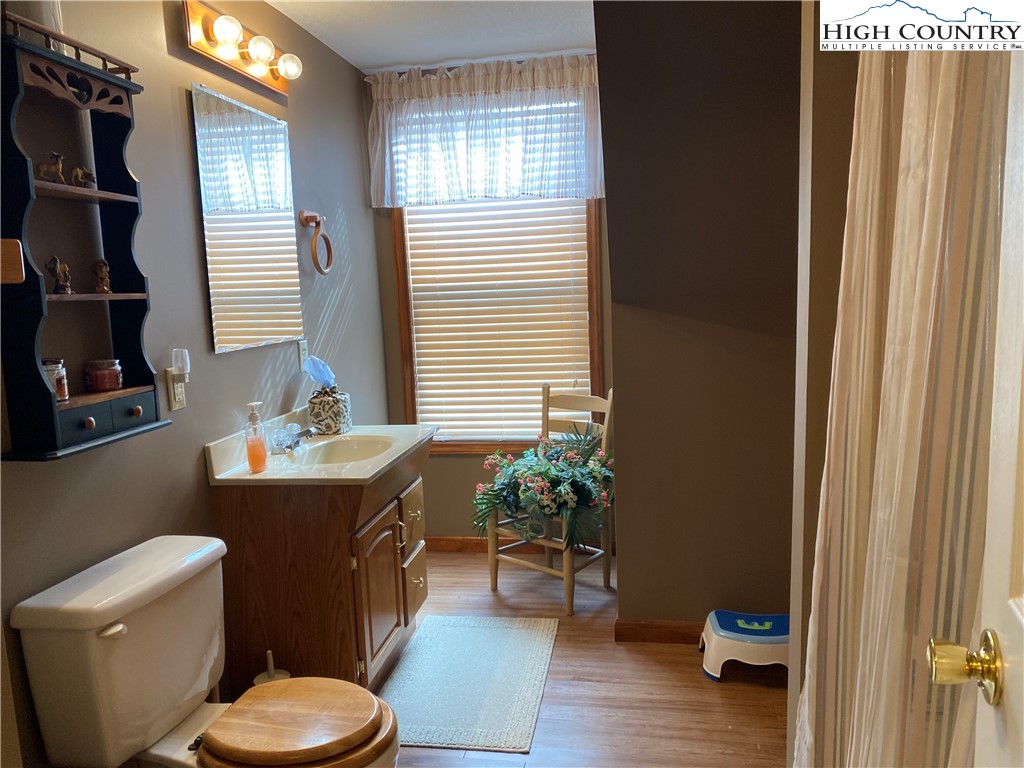 1241 Glade Creek School Road Ennice, NC 28623 - Photo 26 of 49 a bathroom with a granite countertop toilet sink and mirror