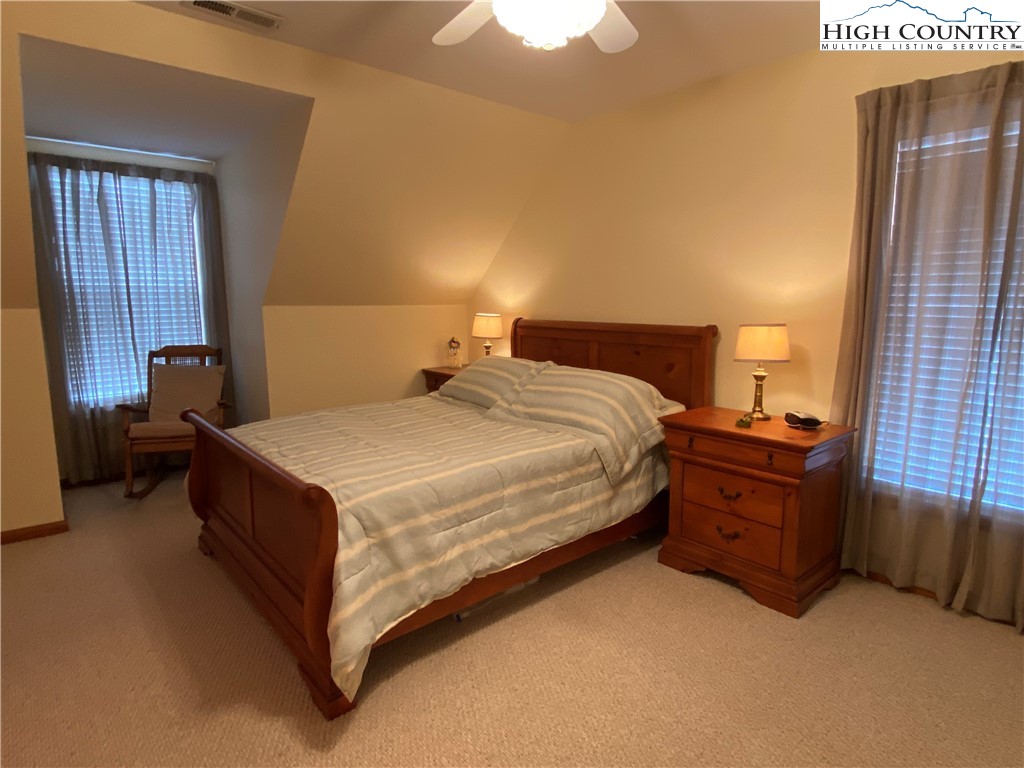 1241 Glade Creek School Road Ennice, NC 28623 - Photo 28 of 49 a bedroom with a bed and window