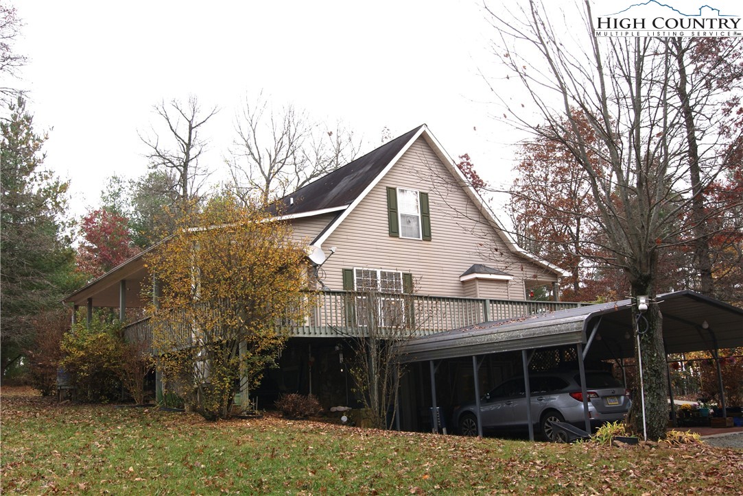 1241 Glade Creek School Road Ennice, NC 28623 - Photo 36 of 49 a view of house with a yard and large trees