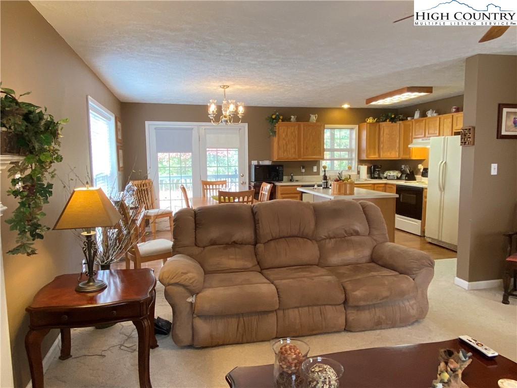 1241 Glade Creek School Road Ennice, NC 28623 - Photo 10 of 49 a living room with furniture kitchen view and a large window