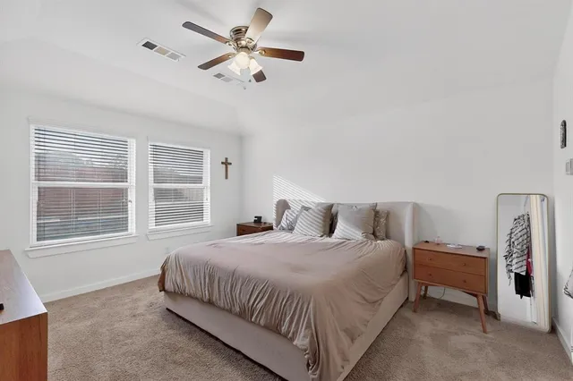 a bedroom with a large bed and a window