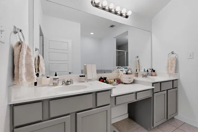 a bathroom with double sink and a mirror