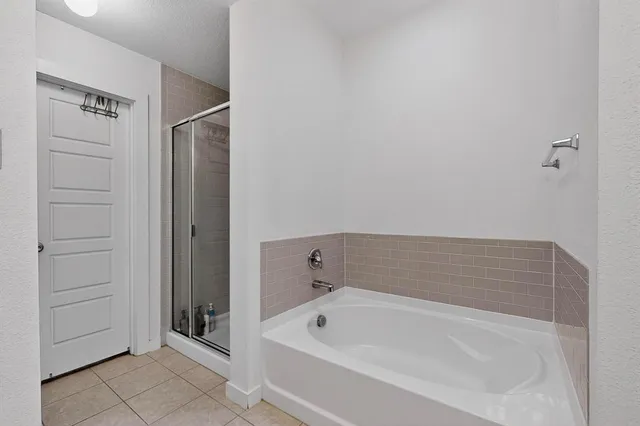 a bathroom with a tub and shower