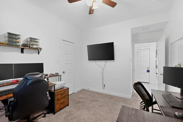 a view of workspace with wooden floor windows