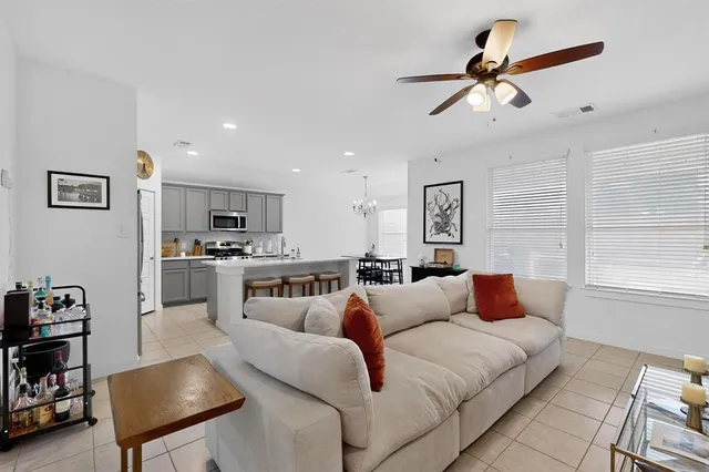 a living room with furniture kitchen and a window