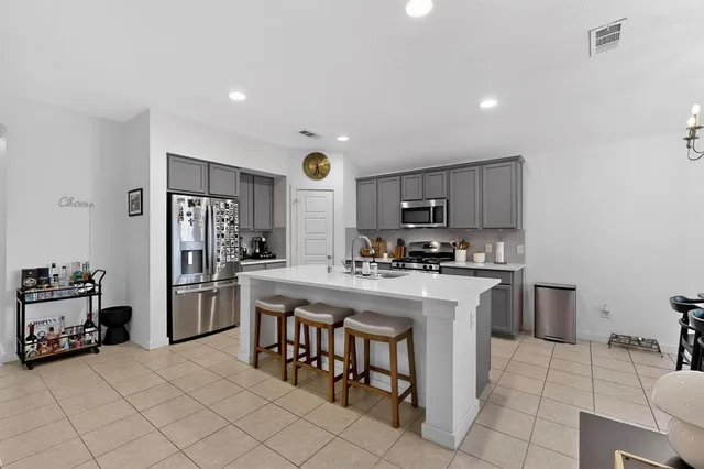 a kitchen with appliances a sink and cabinets