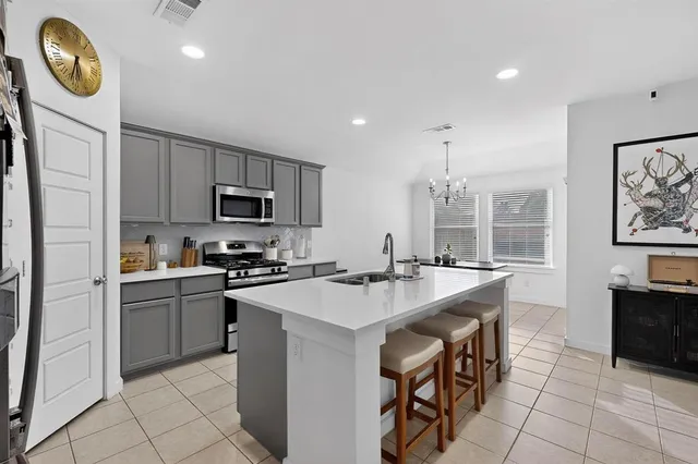a kitchen with appliances cabinets and furniture