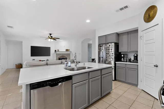 a kitchen with a sink and a refrigerator