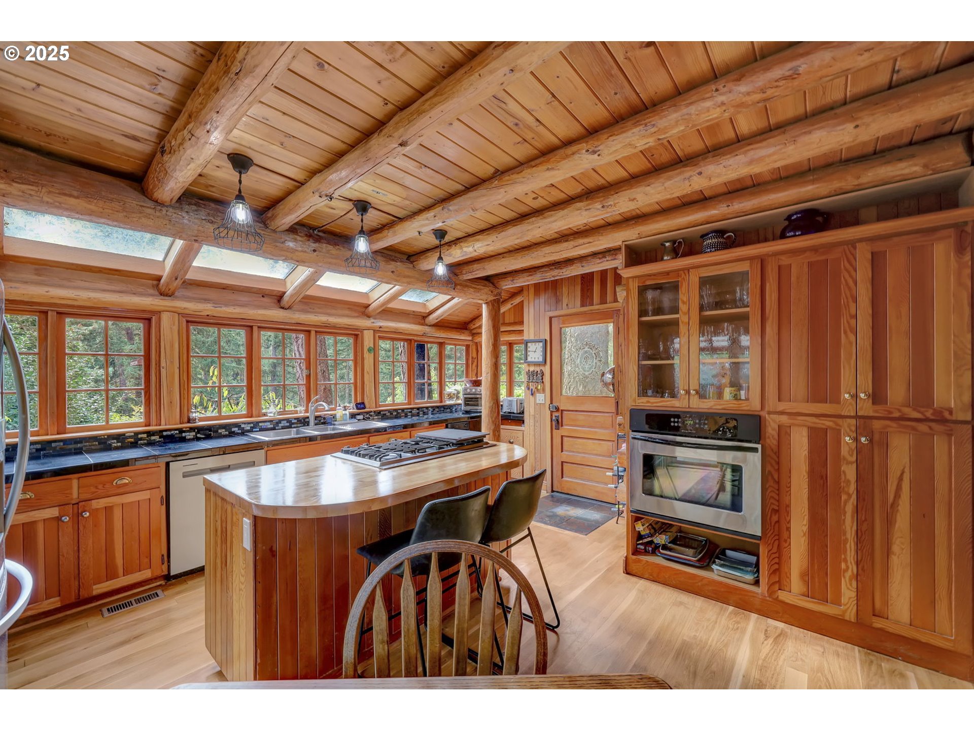 84771 Murdock Road Eugene, OR 97405 - Photo 17 of 46 a kitchen with stainless steel appliances granite countertop a refrigerator and wooden cabinets
