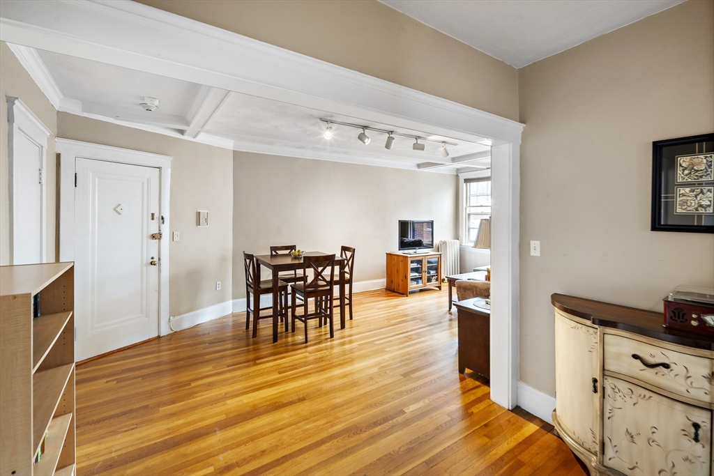 130 Sutherland Road, Unit 12 Boston, MA 02135 - Photo 3 of 17 a view of a dining room with furniture and wooden floor