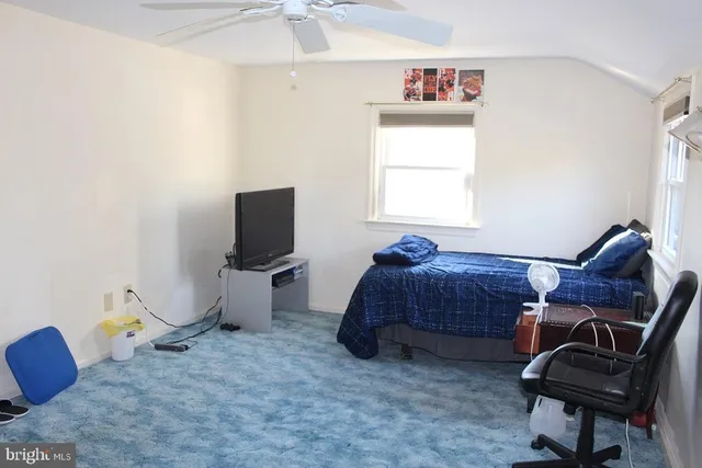 a bedroom with furniture and a window