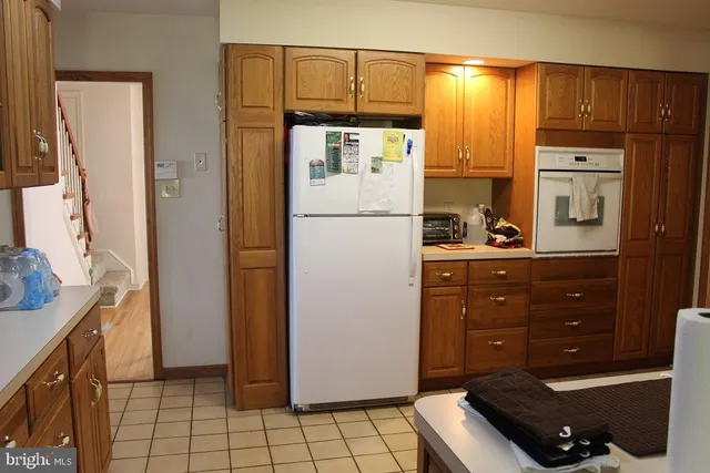 a kitchen with a refrigerator and a stove