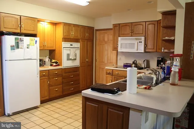 a kitchen with refrigerator cabinets and wooden floor
