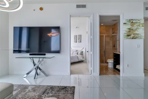 a bedroom with a large bed and a lamp