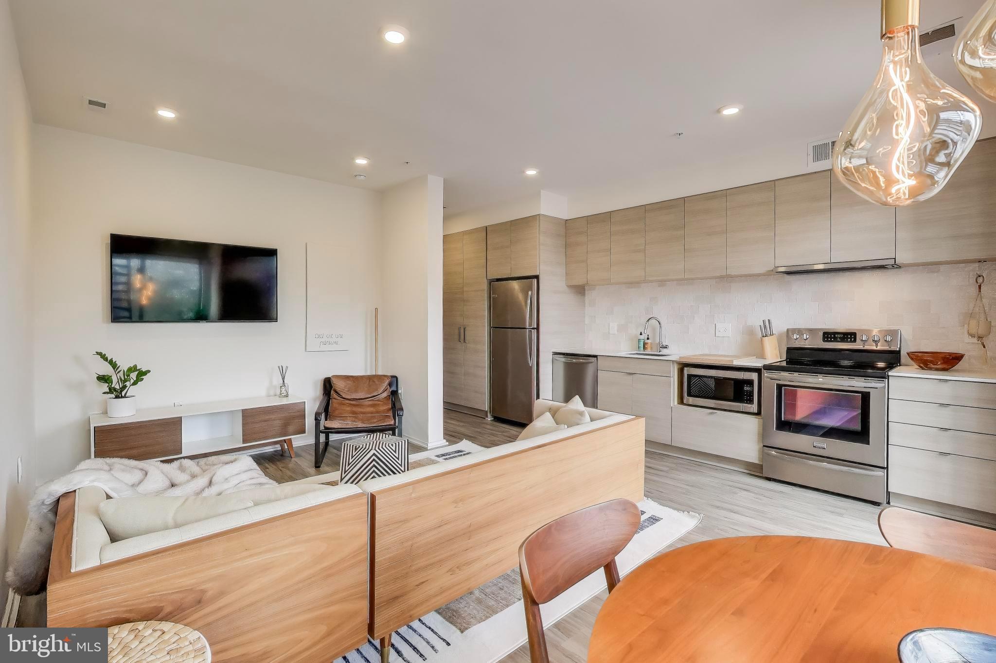 1550 11th Street Northwest, Unit 203 Washington, DC 20005 - Photo 13 of 35 Modern kitchen and living space harmony.