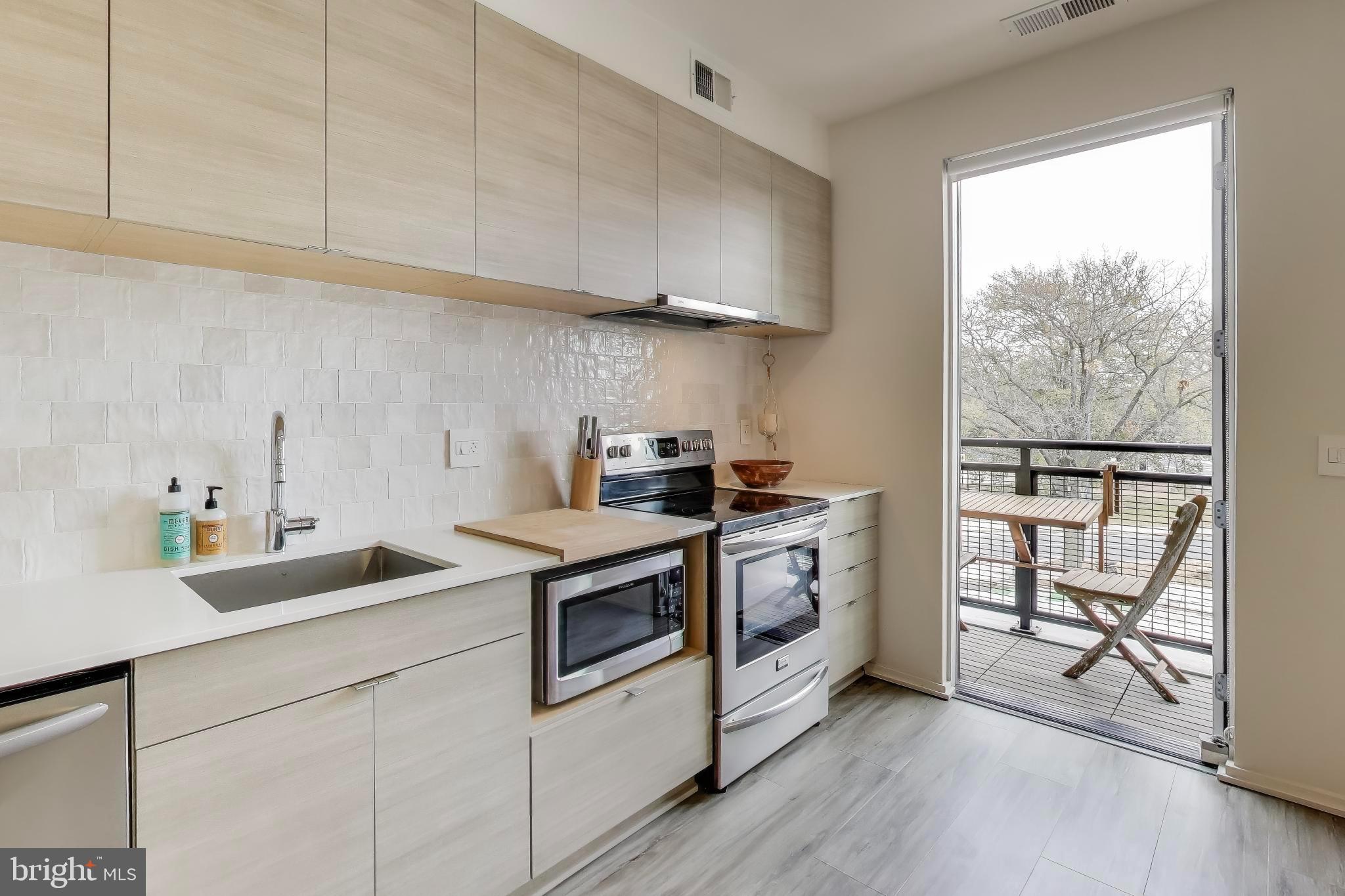 1550 11th Street Northwest, Unit 203 Washington, DC 20005 - Photo 16 of 35 Modern kitchen with balcony access.