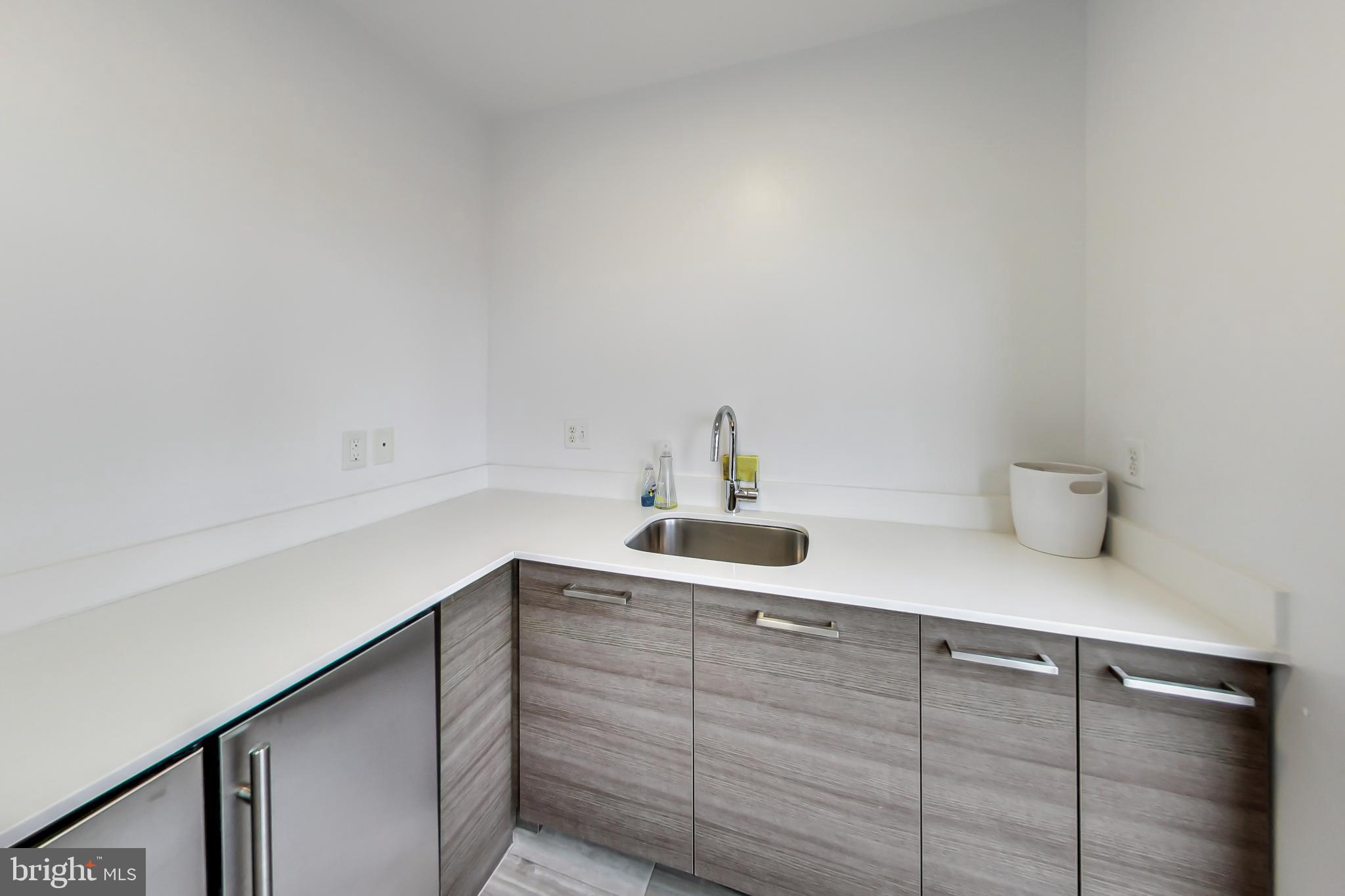 1550 11th Street Northwest, Unit 203 Washington, DC 20005 - Photo 29 of 35 Sleek modern kitchen with minimalist design.