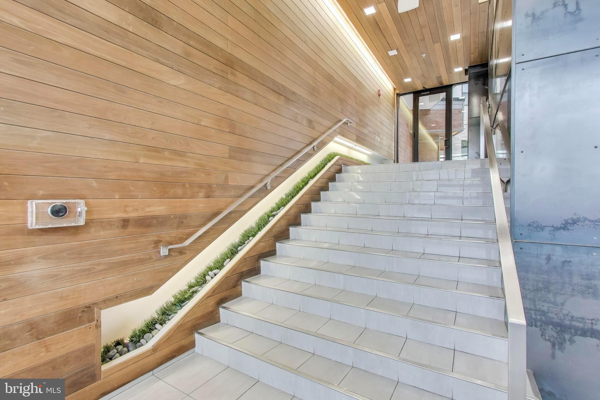 1550 11th Street Northwest, Unit 203 Washington, DC 20005 - Photo 7 of 35 Modern staircase with warm wooden accents.