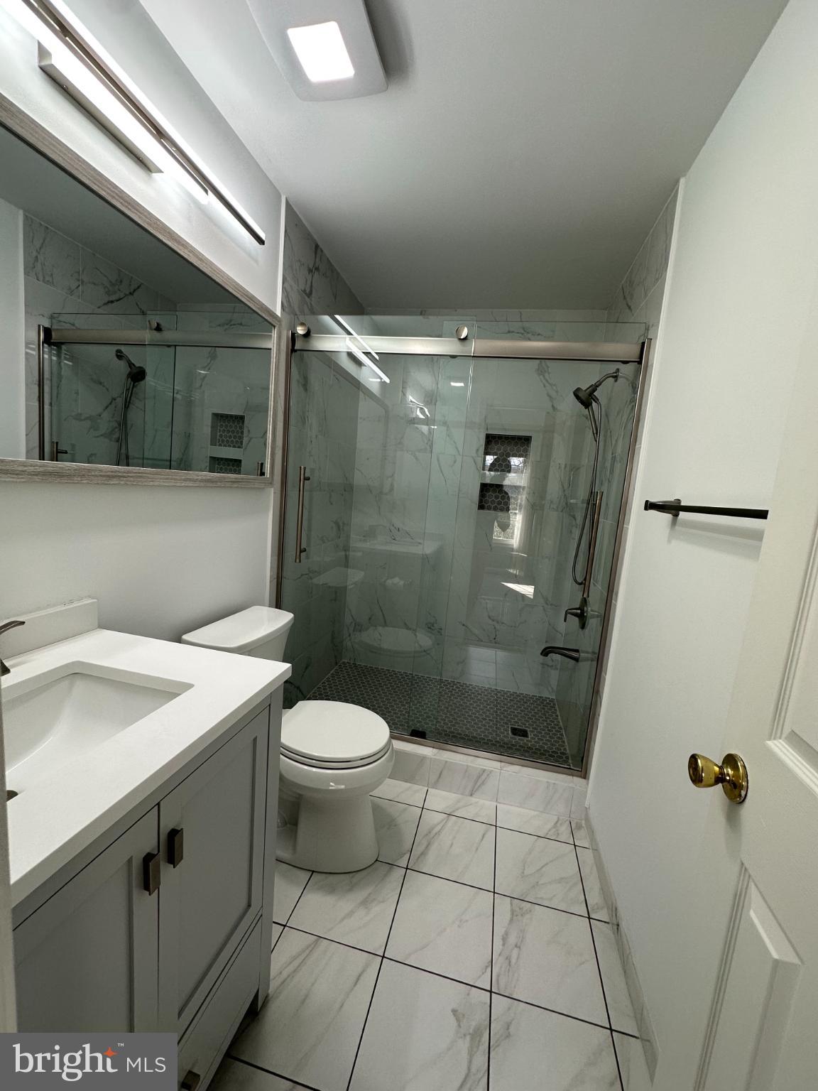 4713 Columbia Road Ellicott City, MD 21042 - Photo 24 of 39 Primary bathroom with sleek glass shower.