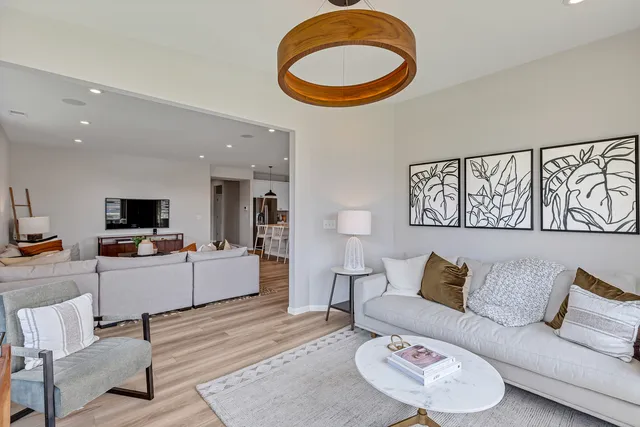 a living room with furniture and a wooden floor