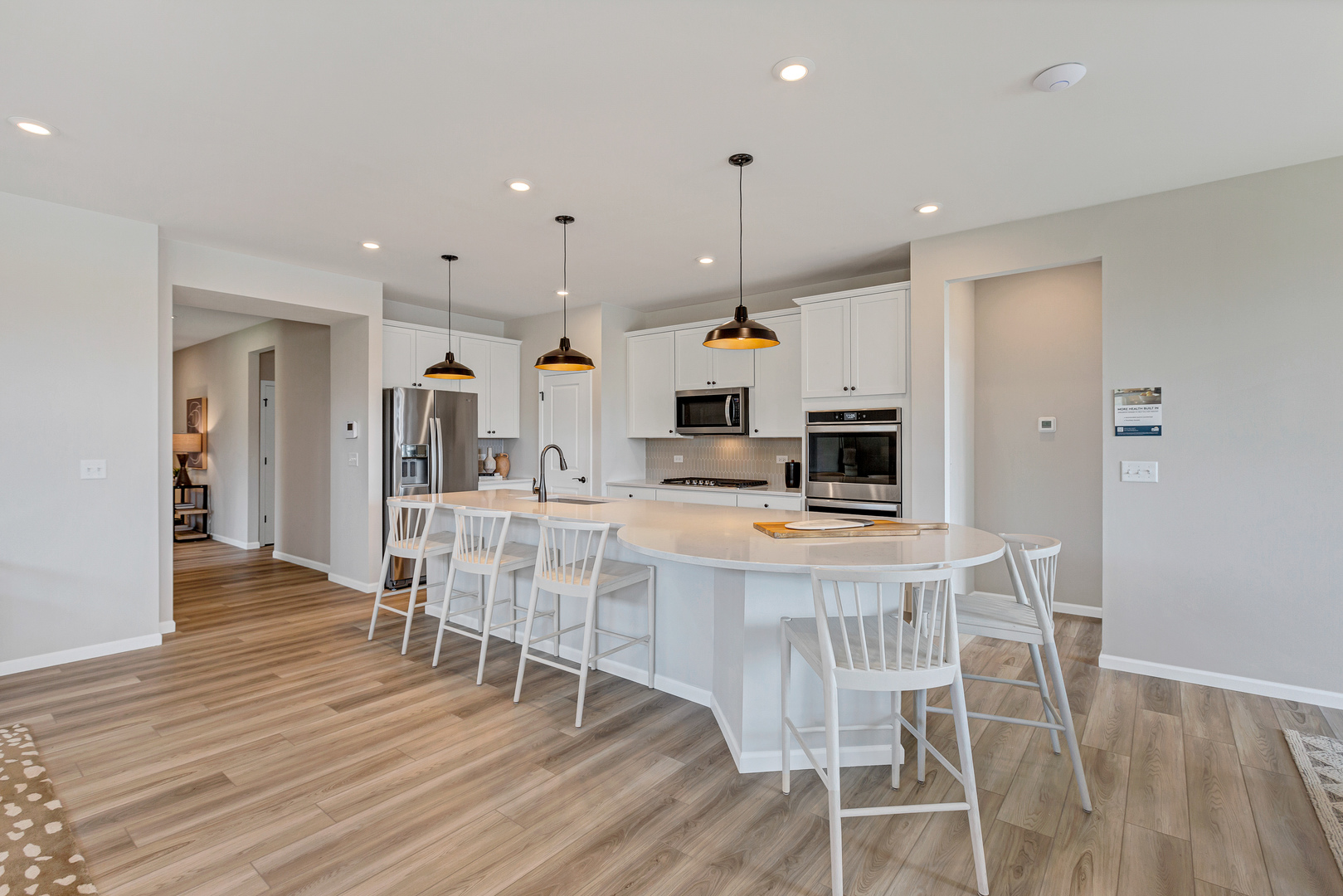 2798 Spring Circle South Lindenhurst, IL 60046 - Photo 2 of 16 a kitchen with stainless steel appliances kitchen island granite countertop a dining table chairs and white cabinets