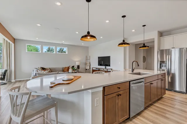 a kitchen with a sink a stove and chairs