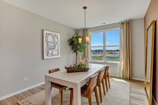 a dining room with furniture and window