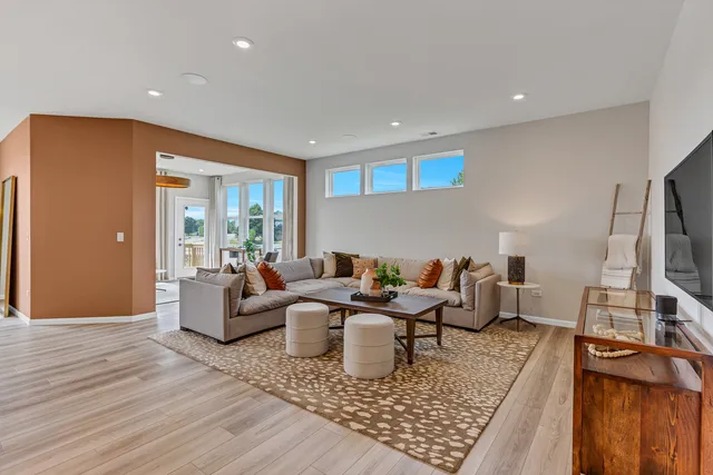 a living room with furniture rug and wooden floor