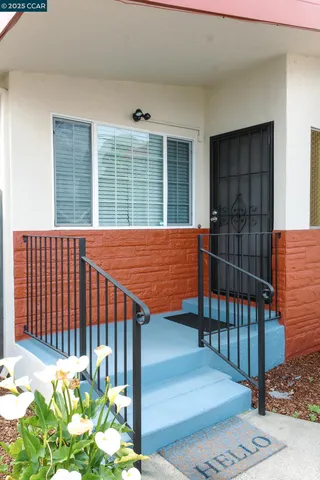 a blue and white umbrella sitting in front of a door