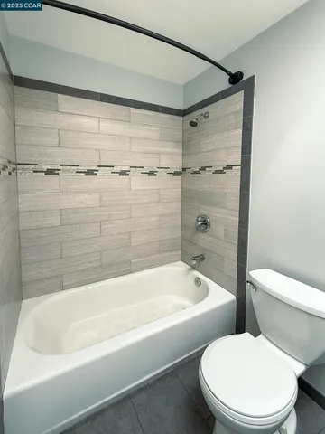 a bathroom with a toilet and bathtub