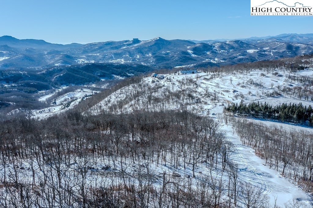 Elderberry Ridge Road Beech Mountain, NC 28604 - Photo 9 of 28 a view of a dry yard with mountains in the background