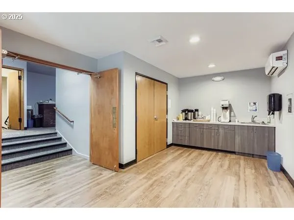 a view of a room with wooden floor and furniture