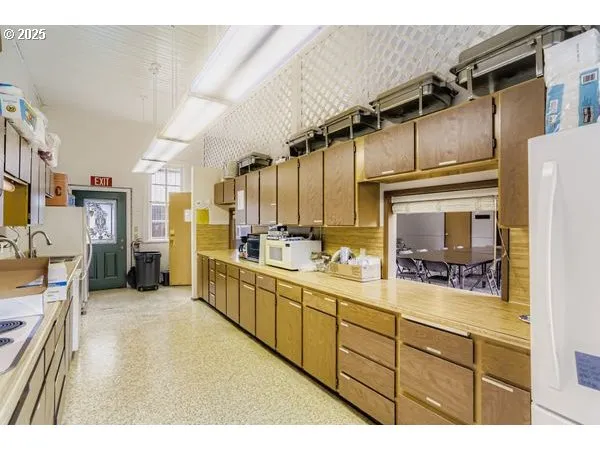a kitchen with refrigerator and cabinets