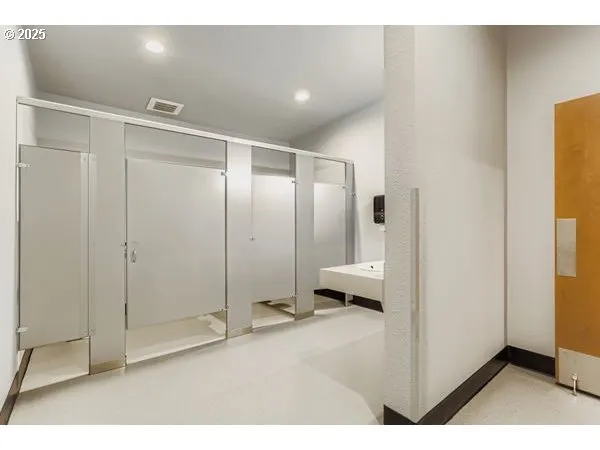a bathroom with a shower and a toilet