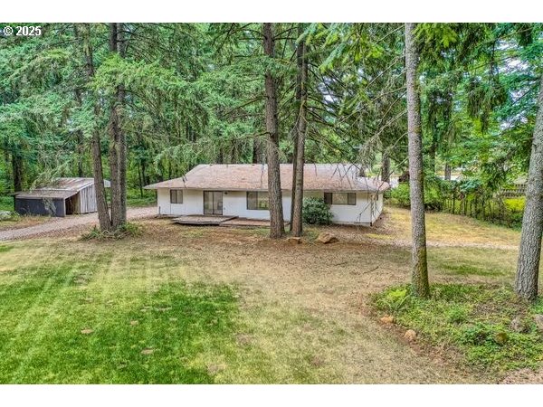 24353 South Ridge Road Beavercreek, OR 97004 - Photo 24 of 33 a backyard of a house with table and chairs