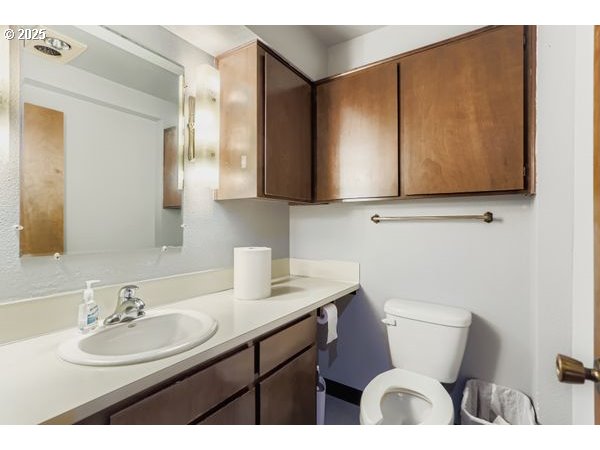 24353 South Ridge Road Beavercreek, OR 97004 - Photo 28 of 33 a bathroom with a sink a toilet and mirror