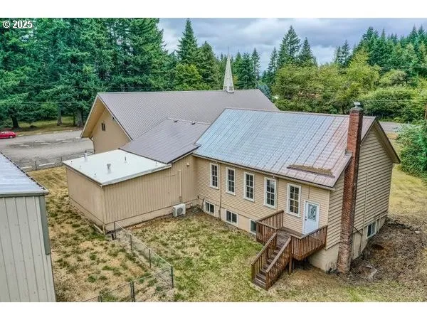 a view of a house with a backyard and porch