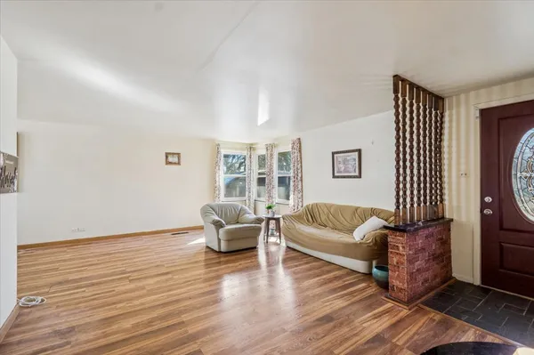 a living room with furniture and a hard wood floor