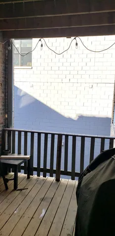 a balcony with wooden floor