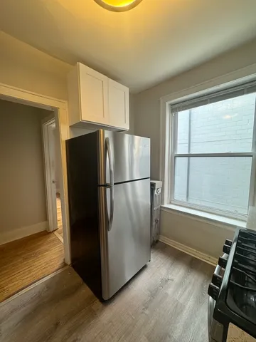 a kitchen with a refrigerator and a window