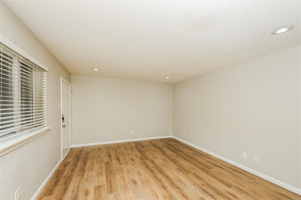 4618 Reiger Avenue, Unit 104 Dallas, TX 75246 - Photo 7 of 19 a view of empty room with wooden floor and fan