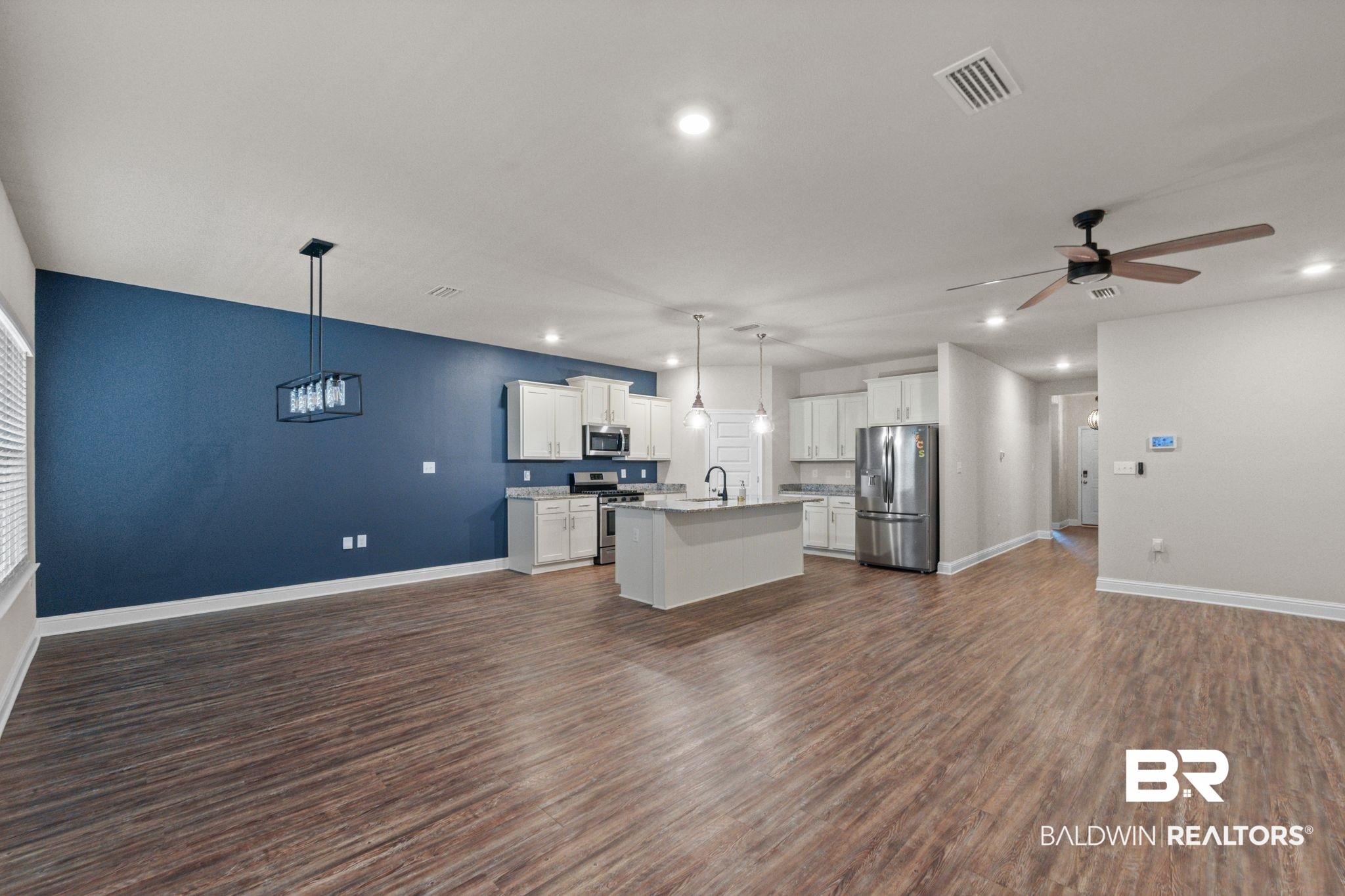 24769 Slater Mill Road Daphne, AL 36526 - Photo 6 of 38 Unfurnished living room with ceiling fan, sink, and dark wood-type flooring