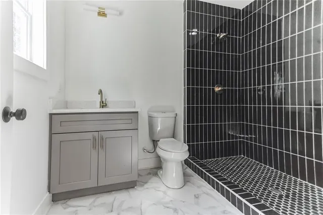 a bathroom with a toilet a sink and mirror