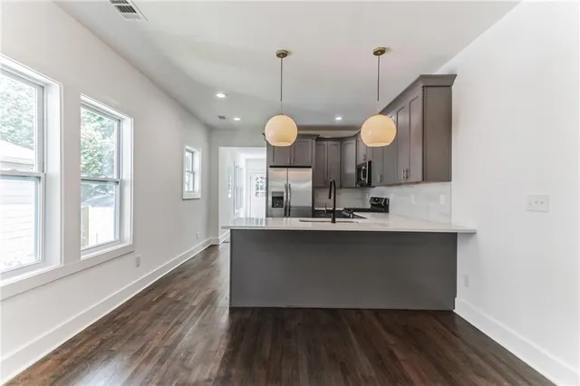 a kitchen with a sink a mirror and window