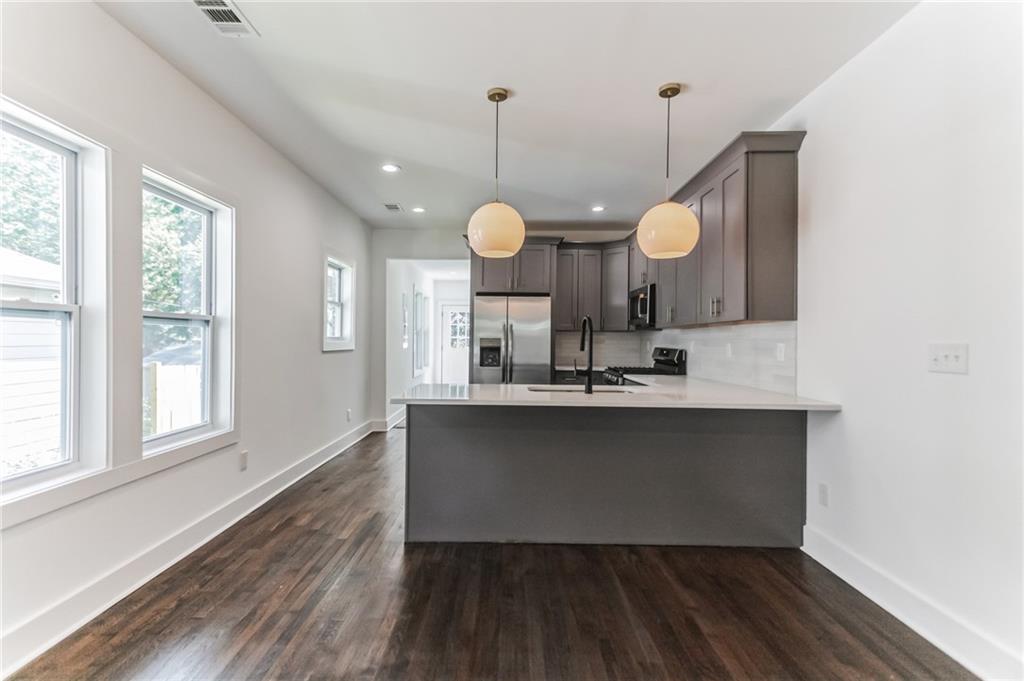 1252 Epworth Street Southwest Atlanta, GA 30310 - Photo 5 of 19 a kitchen with a sink a mirror and window