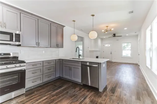 a kitchen with a sink and a stove top oven